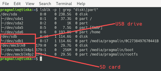 Terminal screenshot that lists the disks and partitions with the lsblk command. It shows how to identify the device names that Linux assigned to the SD card and the USB drive.